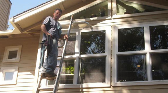 Cleaned windows, owner on ladder
